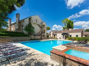 Dallas apartment for rent - a swimming pool with a house in the background