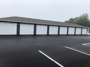 Sister Bay apartment for rent - a row of white garage doors in a parking lot