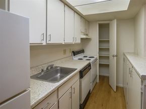 Austin apartment for rent - a kitchen with white cabinets and a sink