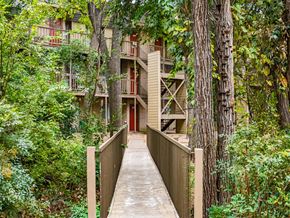 Austin apartment for rent - a bridge leading to an apartment building in the woods