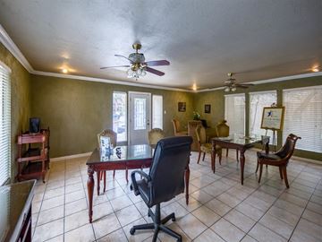 Austin apartment for rent - a living room with a ceiling fan and a table and chairs