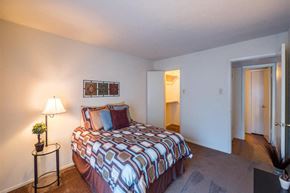 Dallas apartment for rent - a bedroom with a bed and a door to a bathroom