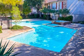 Dallas apartment for rent - a large swimming pool in front of a house