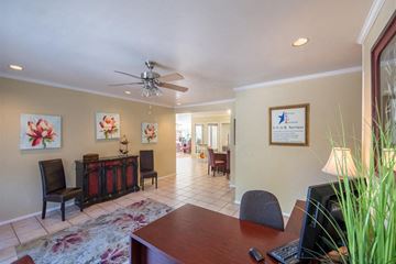 Dallas apartment for rent - a living room with a table and a ceiling fan