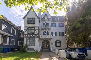 Alameda apartment for rent - A white and black house with a car parked in front.
