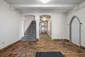 Alameda apartment for rent - A hallway with a staircase and arched doorways.