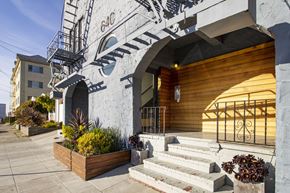 Oakland apartment for rent - A building with a fire escape and a wooden door.