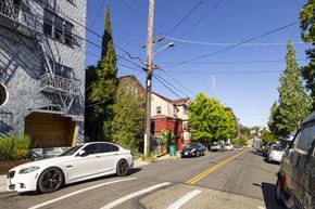 Oakland apartment for rent - A white car is parked on the side of a street.