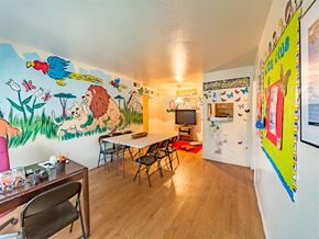 Houston apartment for rent - a dining room with a table and a mural on the wall
