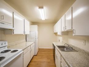 Houston apartment for rent - a kitchen with white appliances and granite counter tops
