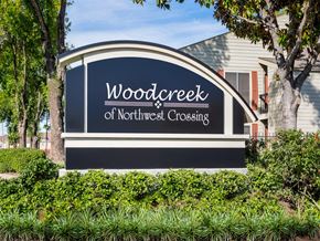 Houston apartment for rent - a sign for wooddeck of northwest crossing in front of a house