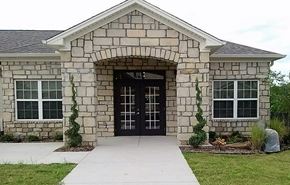 North Little Rock apartment for rent - a stone house with a sidewalk in front of it