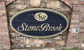 Stilwell apartment for rent - a stone brook sign on a brick wall