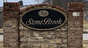 Tahlequah apartment for rent - a stone brick wall with a stone brook sign on it