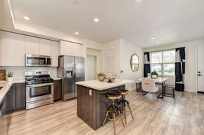 Morgan Hill apartment for rent - kitchen with white cabinets, stainless steel appliances and island counter space with seating at Morgan Ranch Apartments, California, 95037