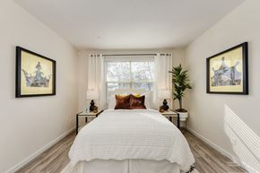 Morgan Hill apartment for rent - Master bedroom with large white bed positioned under the window at Morgan Ranch Apartments, Morgan Hill, 95037