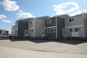 Thompson apartment for rent - A row of houses with a truck parked in front.