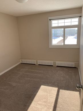 Thompson apartment for rent - an empty living room with a window and carpet