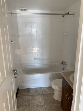 Thompson apartment for rent - a bathroom with a toilet and a tub and a sink