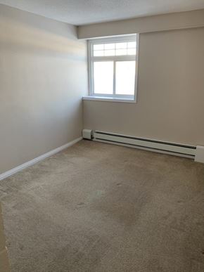 Thompson apartment for rent - A room with a window and a radiator on the wall.