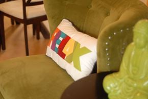 Durham apartment for rent - a pillow on a green chair in a living room