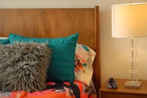 Durham apartment for rent - a bed with pillows and a nightstand with a lamp