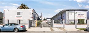 Los Angeles apartment for rent - A car is parked in front of a Now Leasing building.