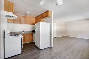 Los Angeles apartment for rent - A kitchen with white appliances and wooden cabinets.