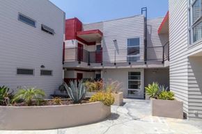 Los Angeles apartment for rent - A modern house with a red accent wall and a landscaped front yard.