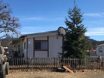 Hayfork house for rent - A house with a basketball hoop in the backyard.