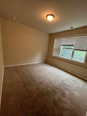 Atlanta house for rent - a bedroom with a large window and a carpeted floor