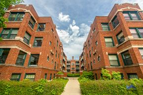 Chicago apartment for rent - a row of red brick apartment buildings with a pathway between them