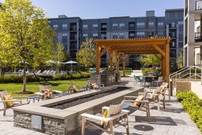 Malden apartment for rent - an outdoor lounge area with tables and chairs in front of a building