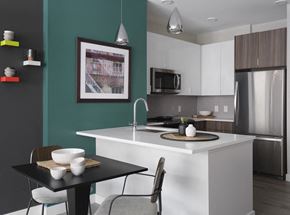 Malden apartment for rent - a kitchen with a large island and a table with chairs