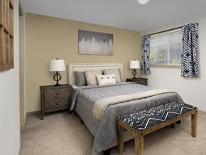 Gladstone apartment for rent - A bedroom with a bed, nightstand, and window.