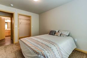 Fargo apartment for rent - a bedroom with a bed and a door to a bathroom