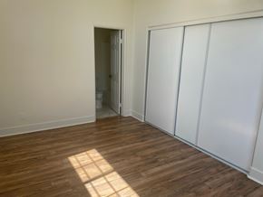 Laguna Niguel apartment for rent - a bedroom with white walls and wood flooring and a closet
