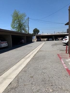 Downey apartment for rent - a street with cars parked under an overpass