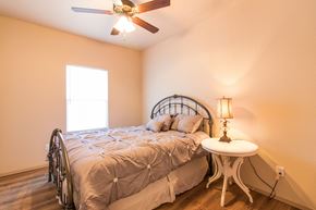Gentry apartment for rent - a bedroom with a bed and a ceiling fan