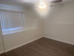 Los Angeles apartment for rent - A room with a ceiling fan and a window with blinds.