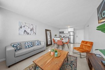 Miami apartment for rent - a living room and dining room with a couch and a table