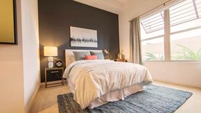 San Bruno apartment for rent - a bedroom with a bed and a large window