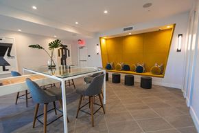 Canoga Park apartment for rent - a dining room with a glass table and chairs