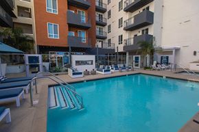 Canoga Park apartment for rent - a swimming pool in front of an apartment building