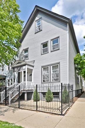 Chicago apartment for rent - a white house with a fence in front of a sidewalk