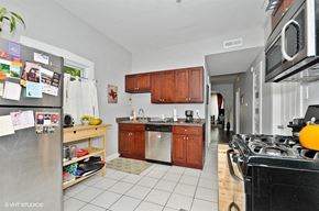 Chicago apartment for rent - a kitchen with stainless steel appliances and wooden cabinets