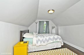 Chicago apartment for rent - a bedroom with a bed and a yellow dresser