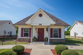 Van Buren triplex for rent - a house with a red door and a sidewalk in front of it