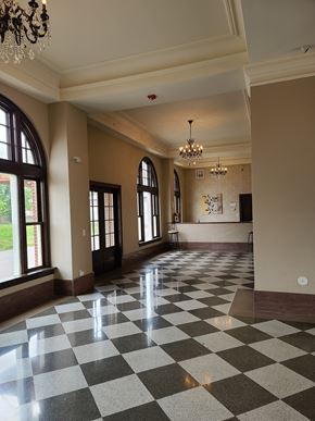 Durant apartment for rent - a lobby with a checkered floor and a chandelier