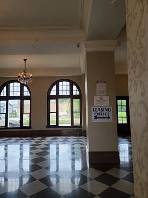 Durant apartment for rent - a lobby with large windows and a leasing office sign